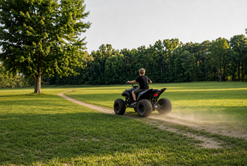 36v ride on mini quad pro being ridden in backyard